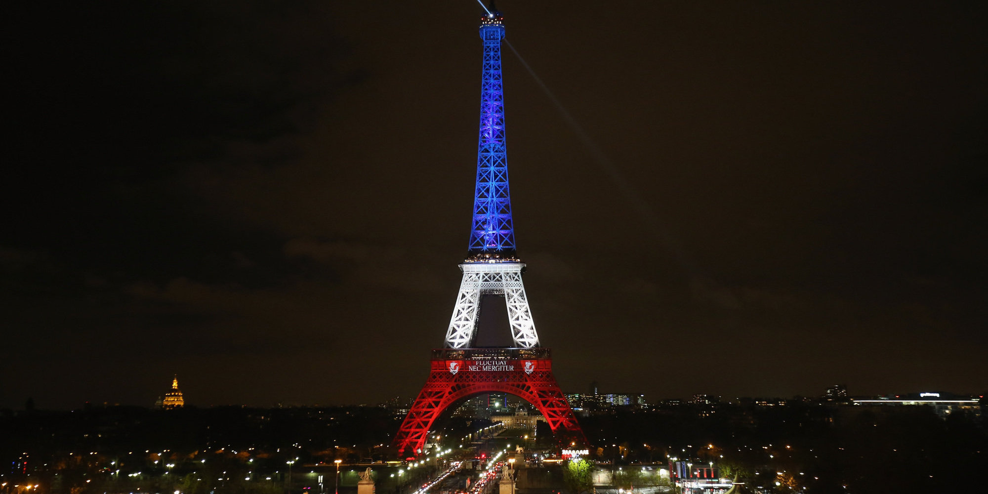 PARIS, FRANCE - NOVEMBER 16:  The Eiffel Tower is illuminated in Red, White and Blue in honour of the victims of Friday's terrorist attacks on November 16, 2015 in Paris, France. Countries across Europe joined France today to observe a one minute-silence in an expression of solidarity with the victims of the terrorist attacks, which left at least 129 people dead and hundreds more injured.  (Photo by Christopher Furlong/Getty Images)